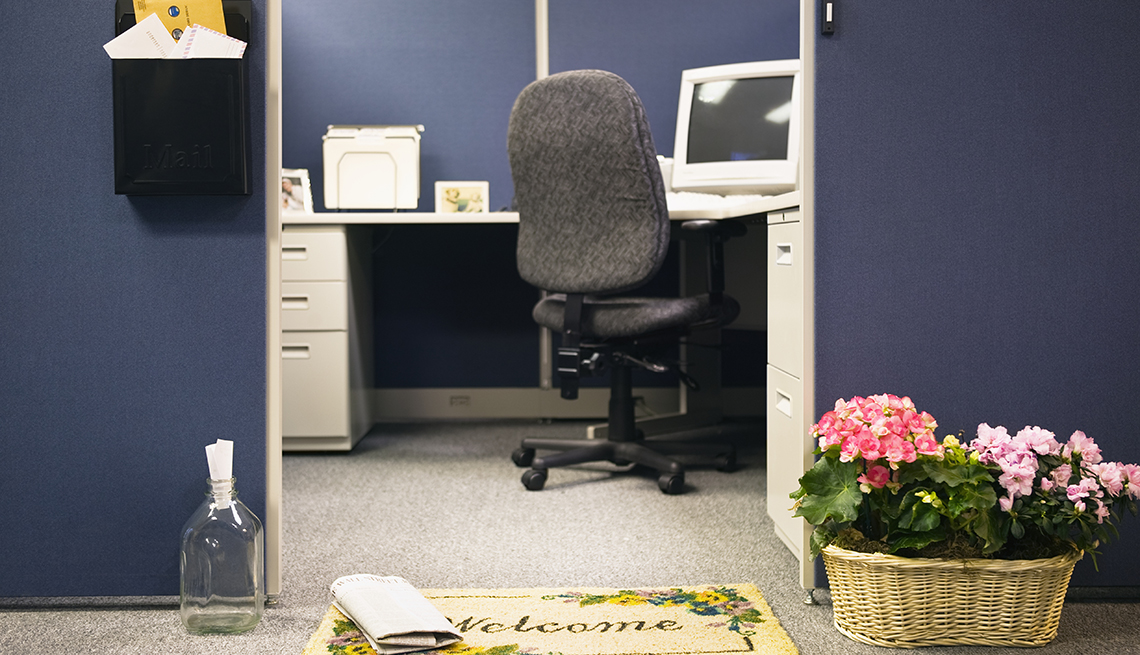 An office cubicle with flowerpots and welcome mat. Workplace Hearing Loss coping strategies