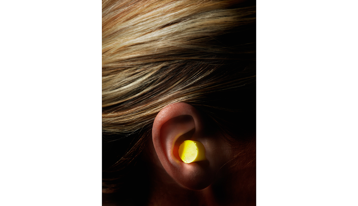 Closeup of ear plug in ear, Tips to Protect Your Hearing