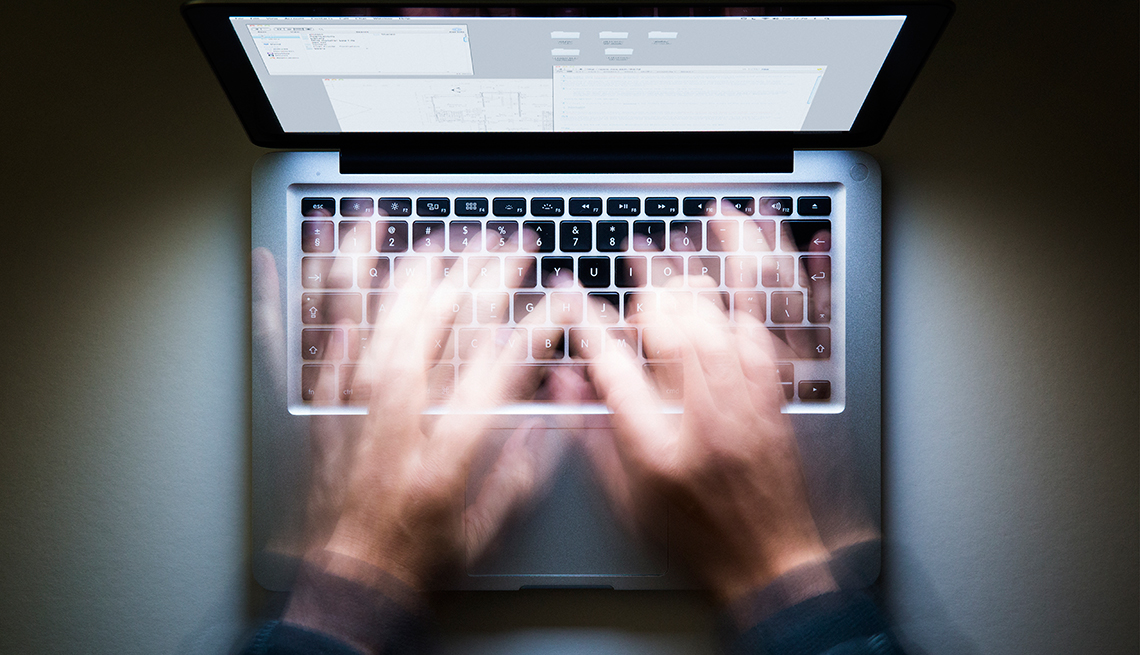 Hands in motion blurred over a laptop keyboard, Workplace Hearing Loss coping strategies