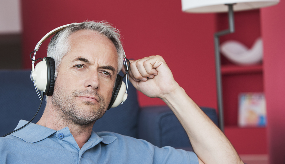 Man listening to headphones, Tips to Protect Your Hearing