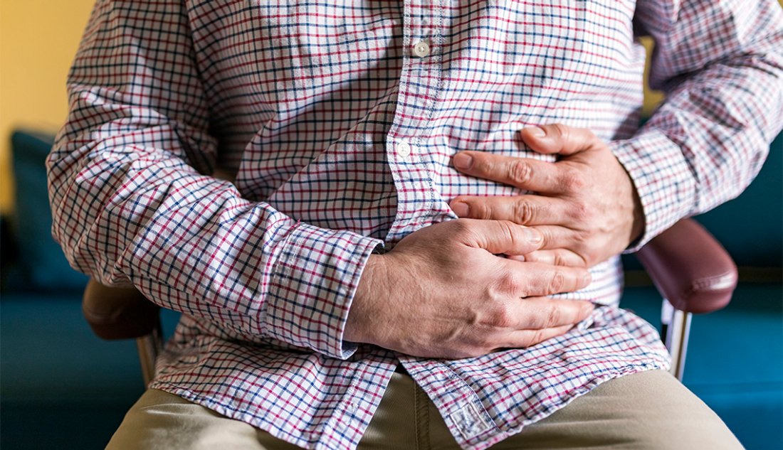 man holding his stomach in pain