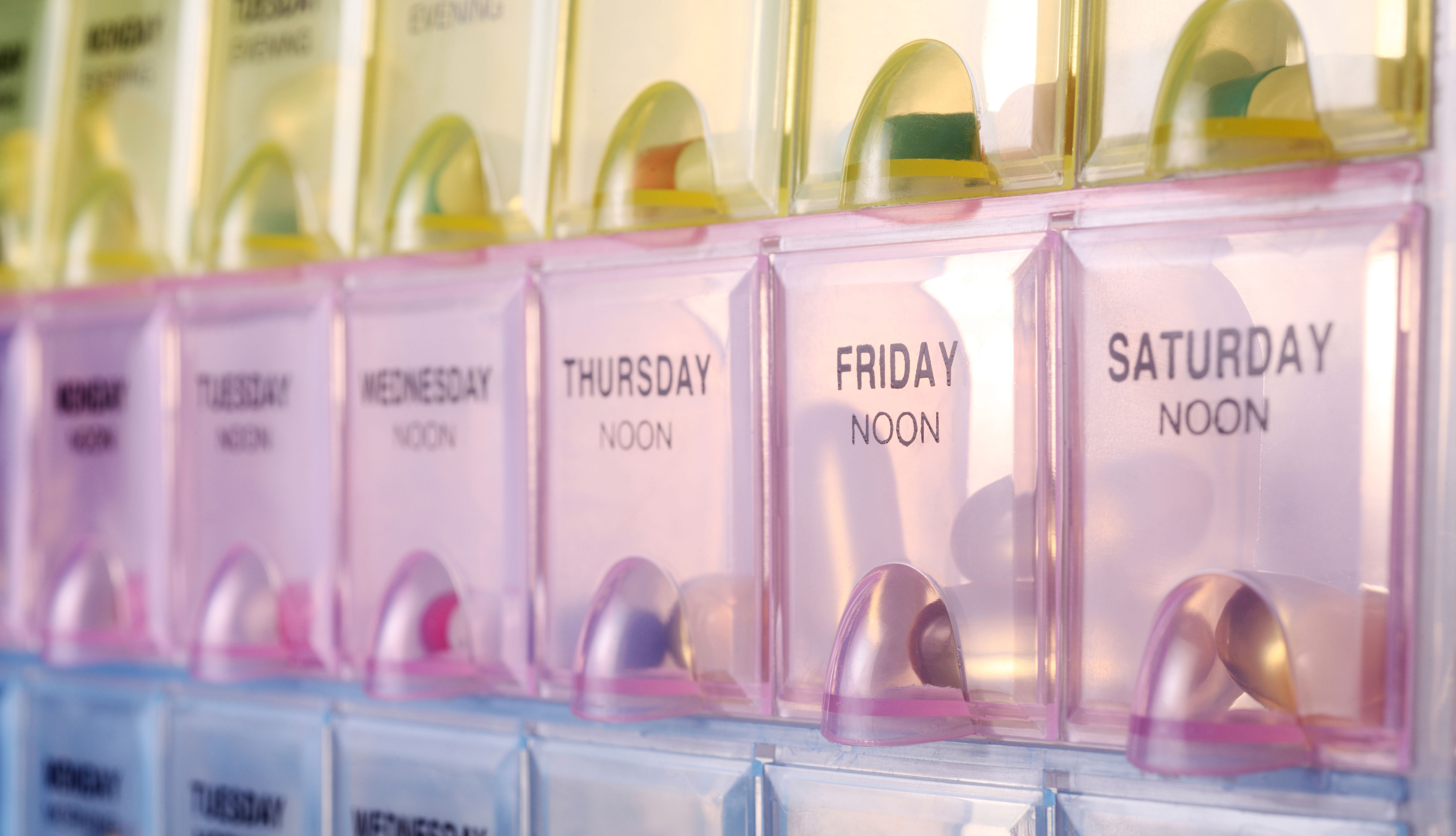 close up of colorful daily pills box