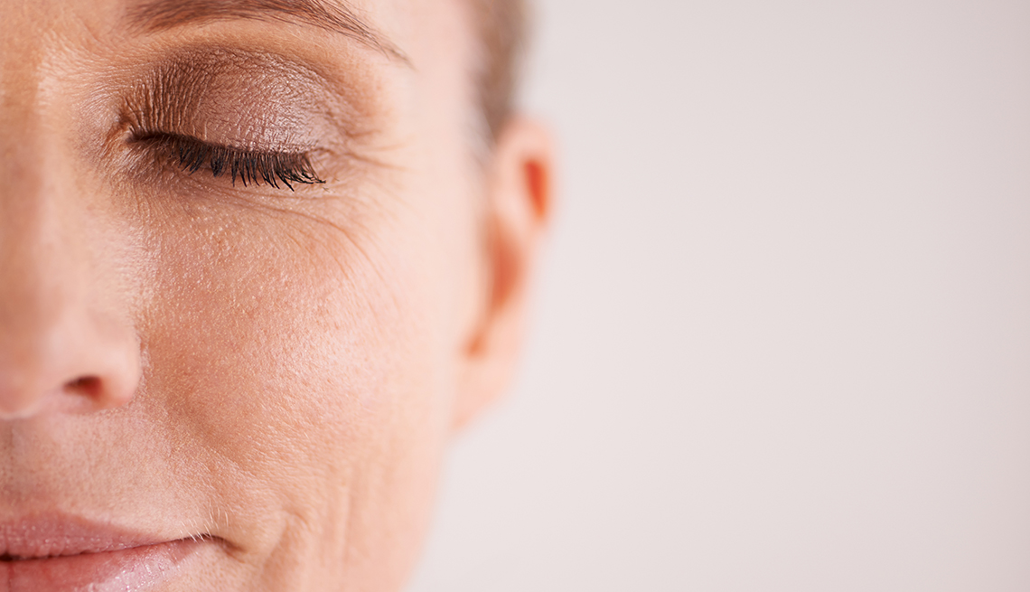 Closeup of a woman wearing eye makeup.
