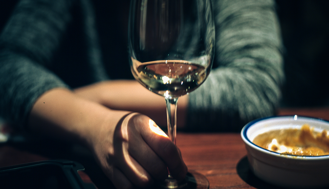 woman's hand holding a wine glass