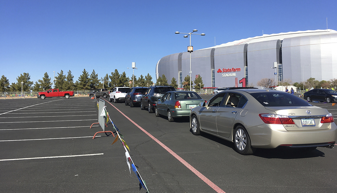 item 8 of Gallery image - drivers wait in their cars in line for the covid vaccine at state farm stadium in glendale arizona 