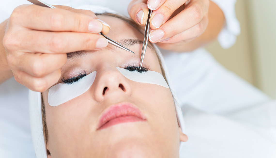 Woman getting eyelash extensions put on