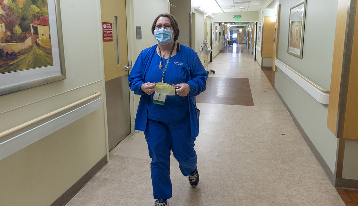 nurse walks down a hospital corridor