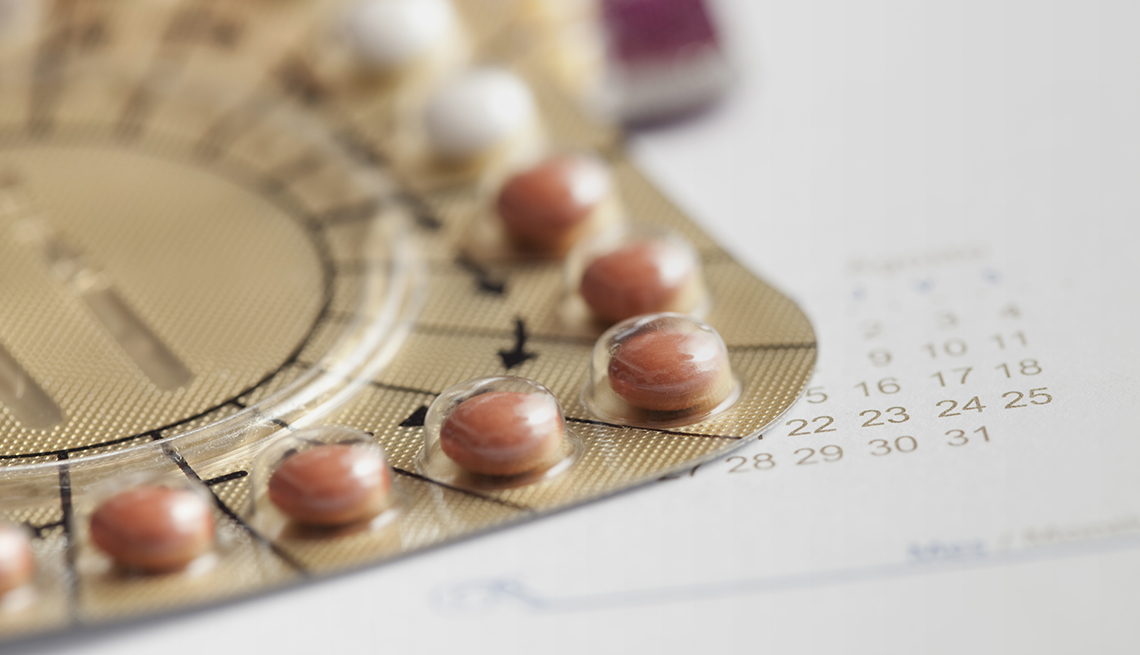closeup of a hormone replacement pill package sitting on top of a monthly calendar
