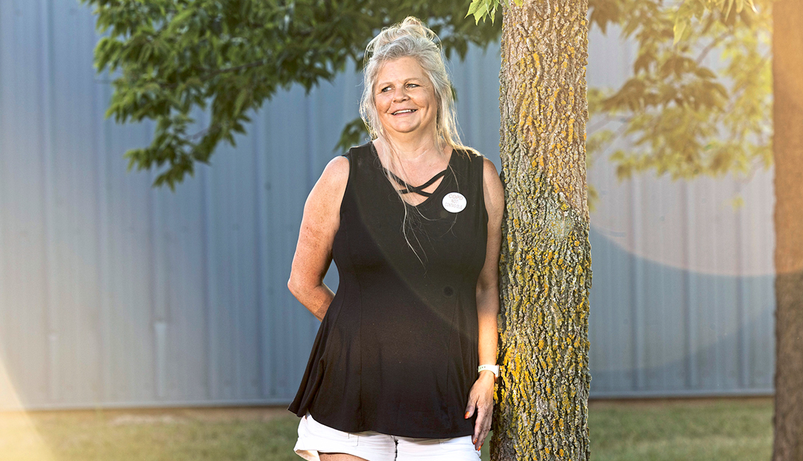 Lisa Hall habla sobre su asma y EPOC, recostada de un árbol en un patio