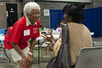 volunteer helps patient at free health clinic