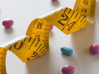 Pills scattered around a tape measure. Some medicines can make you gain weight.