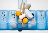 Taking multiple medications and vitamin supplements may be too much- a pillbox full of medication and vitamin pills