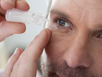 Mature man applying eye drops into eye - Beware of a drug for dry eyes