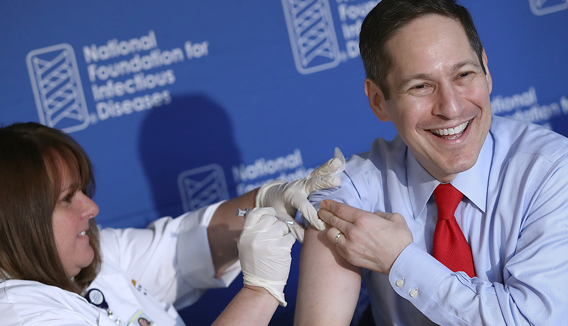 Dr. Tom Frieden (R), director of the Centers for Disease Control and Prevention, receives his annual flu shot