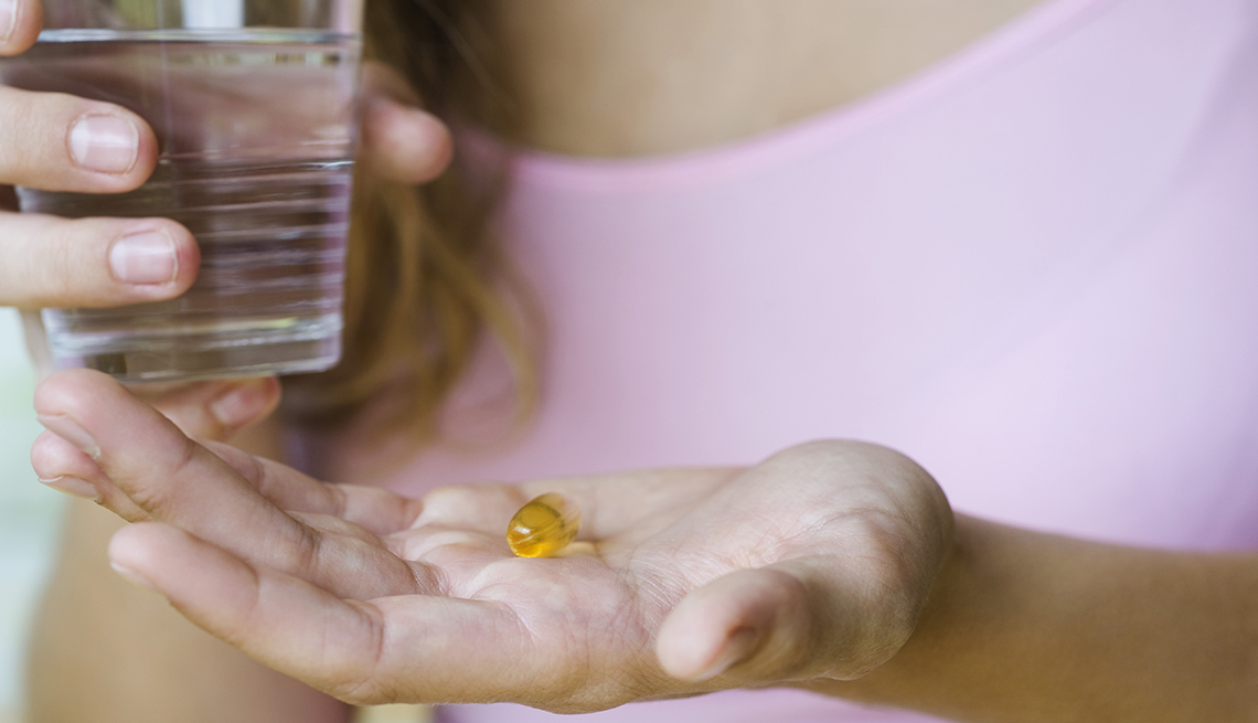 woman taking a vitamin supplement