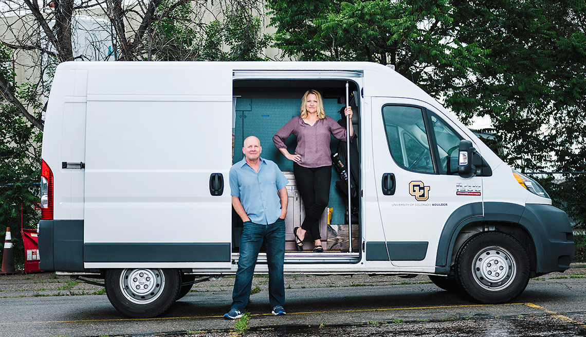 University of Colorado at Boulder professors Kent Hutchison and Angela Bryan stand in front of a white cargo van known as the CannaVan