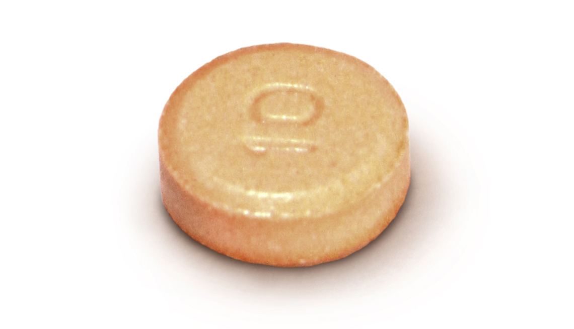 item 4 of Gallery image - a small orange propranol pill is shown and features the inscription of 10  on the front