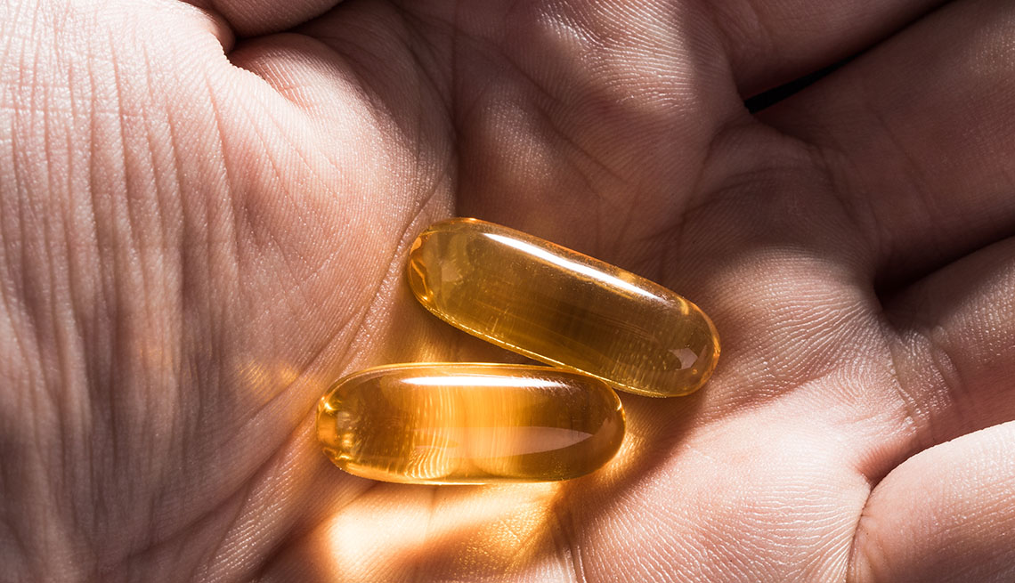 vitamin capsules in palm of hand