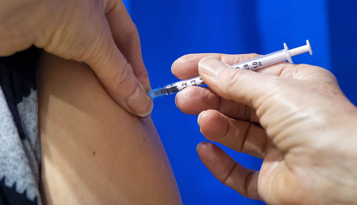 A close-up of a syringe containing a Pfizer-BioNTech Covid-19 vaccine as it is given to a patient in Cardiff, Wales