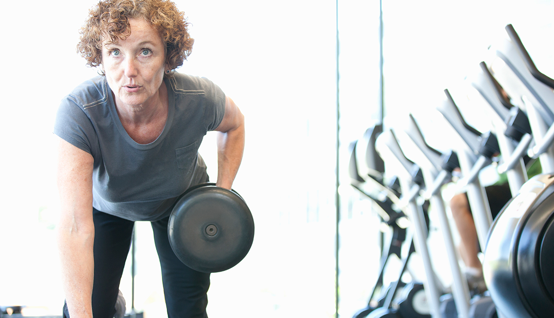 Woman lifting weights, Chatzky: Open Enrollment 