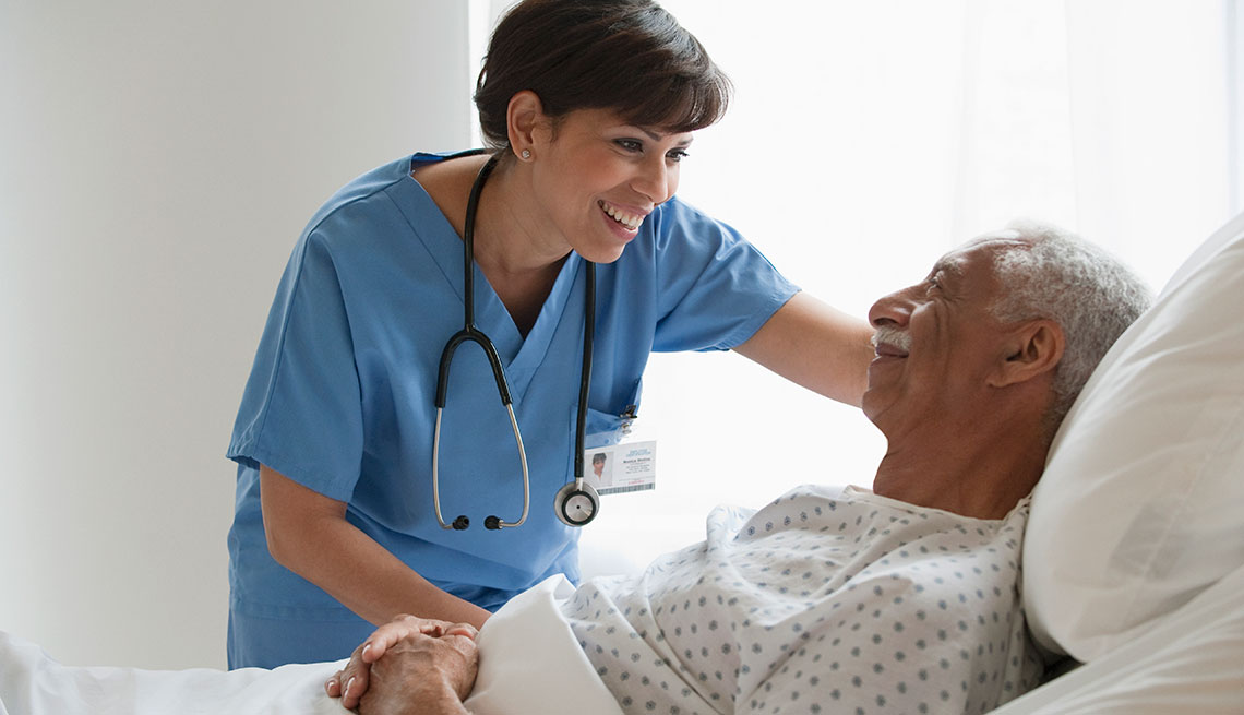 Nurse smiling while talking to a patient 