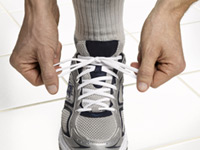 lacing up athletic shoe - New study suggests that middle-aged adults recently diagnosed with diabetes and hypertension may have more time to try to control their high blood pressure without medications.
