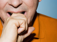 Man biting knuckle, The Fear Project by Angel Livas (Image Source/Corbis)