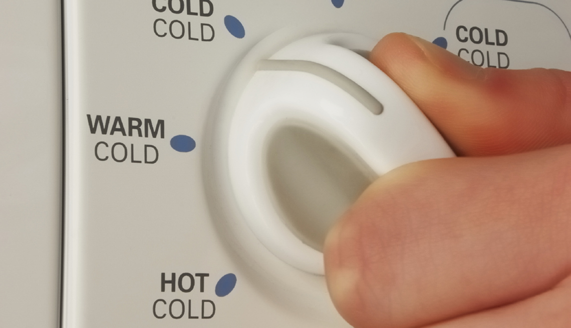 Fingers On Laundry Machine Dial, AARP Health, Think Before You Go Green