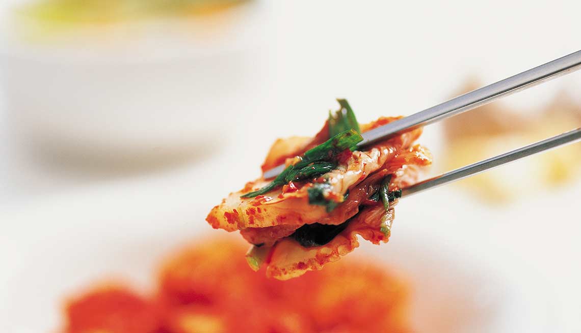 Kimchi on chopsticks, Foods That Help Your Gut