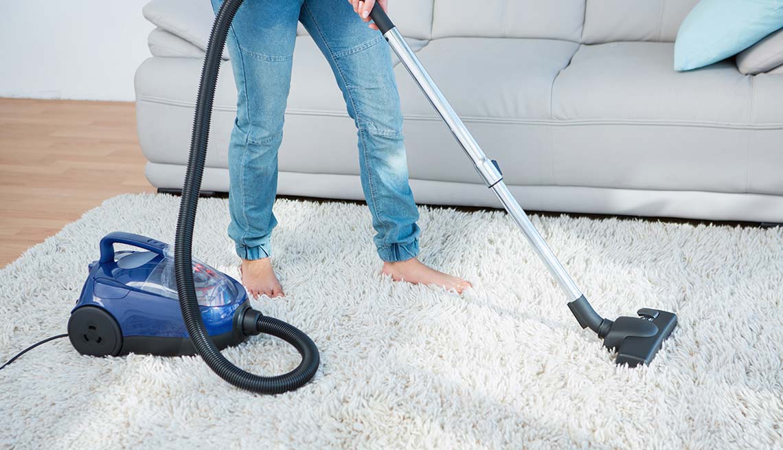 Woman vacuums white rug, Cheap Creative Workout, Home Exercise
