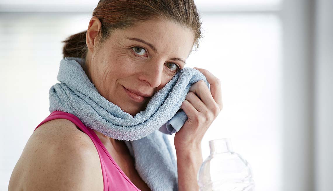 Woman dries her face after exercise