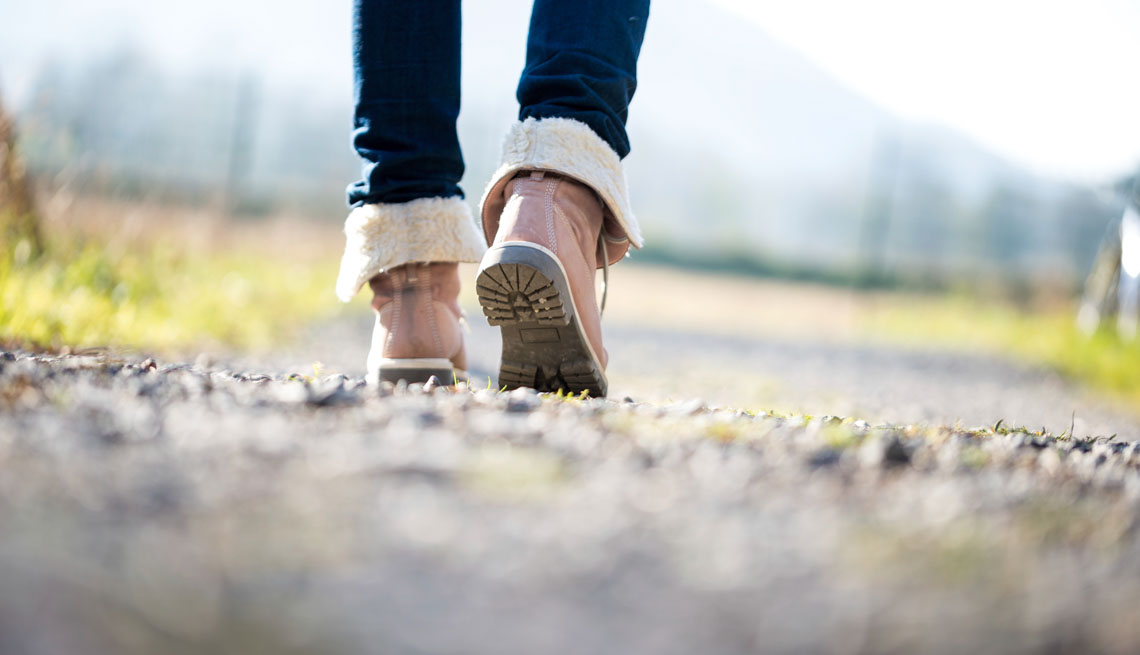 Woman walking on a rural path, 7 Ways to Make Your Morning Healthier