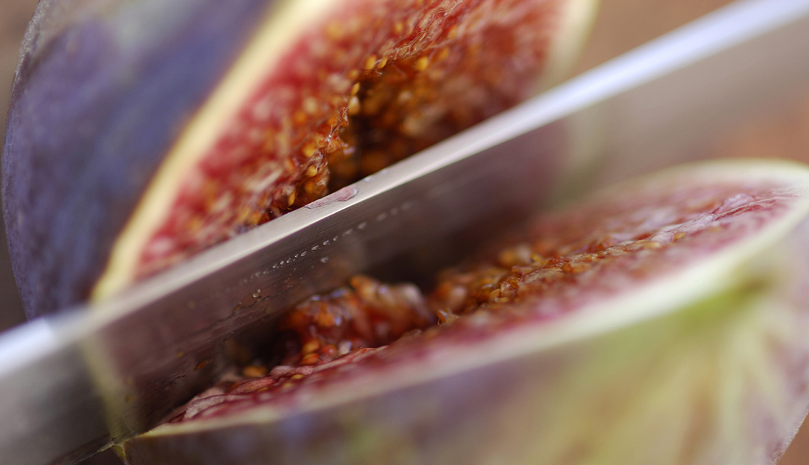 Knife slicing a fig, Fat Busting Fall Foods