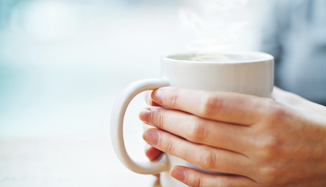 Woman's hands hold white cup of hot beverage, Skipping Breakfast, Habits That Are Good For You