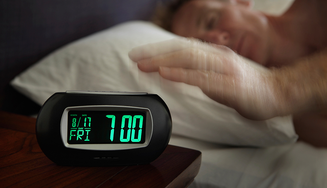 Man reaches for Alarm clock, Nine Numbers Extend Life, 7 Hours Sleep Needed
