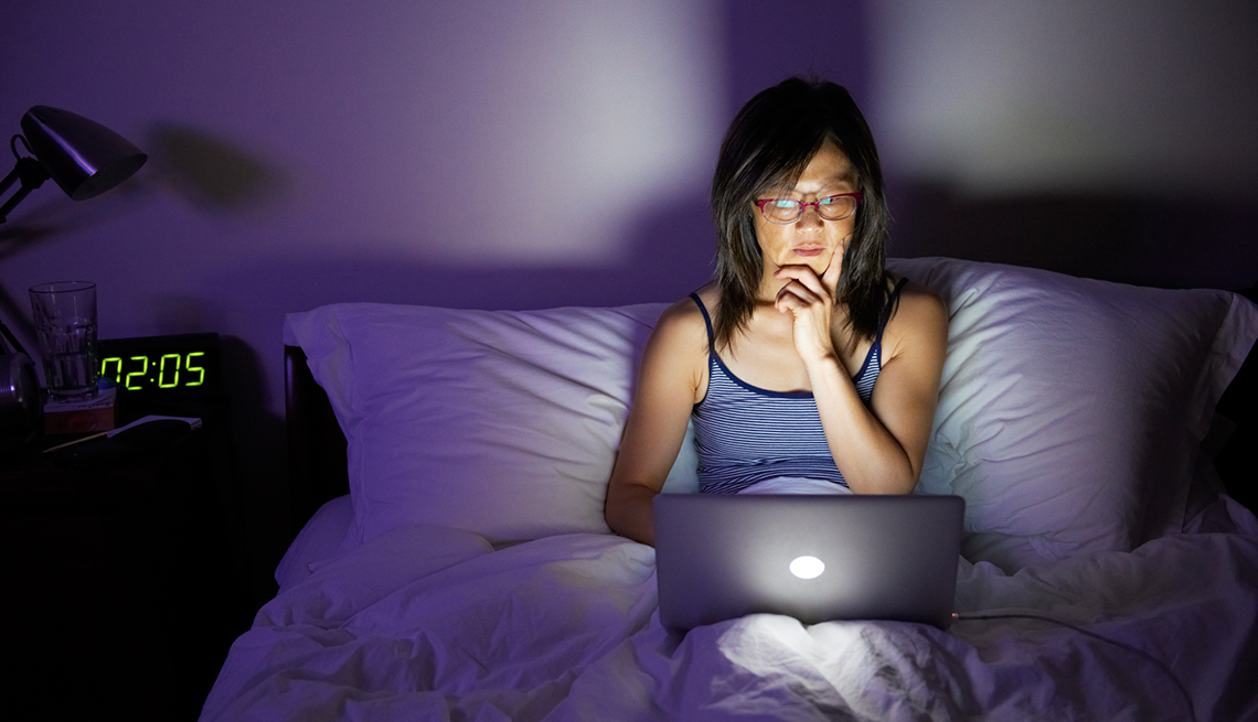 Woman with laptop in bed, Good Habits Go Bad