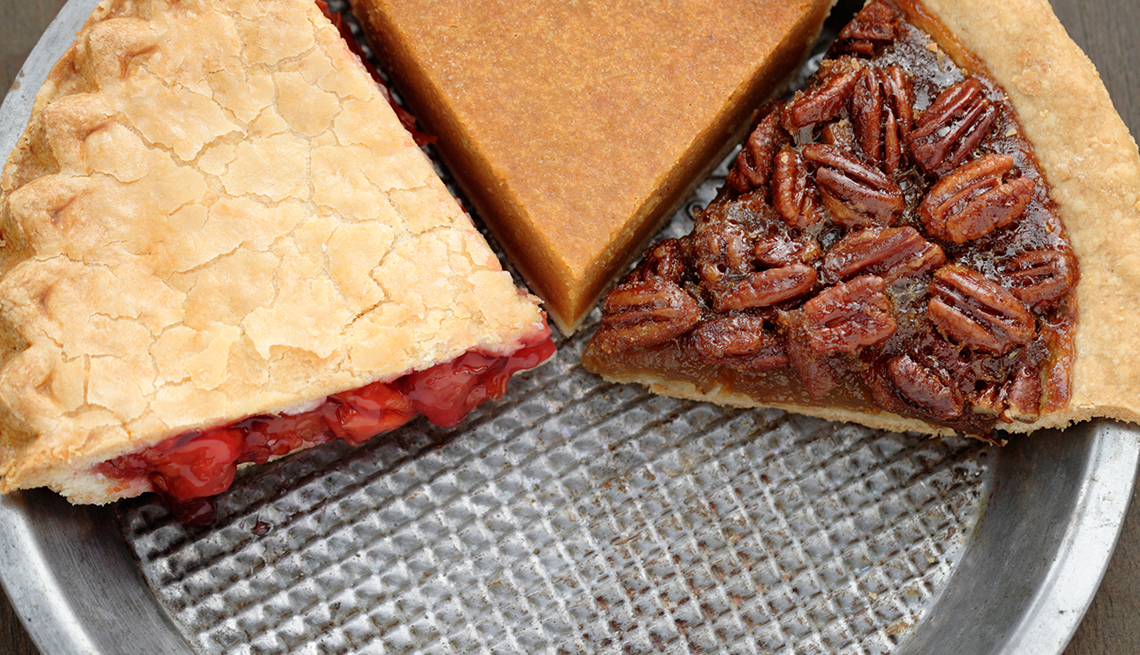 Slices of pie in a pan, pecan, cherry and pumpkin pie slices, How Not to Gain Those 10 Holiday Pounds
