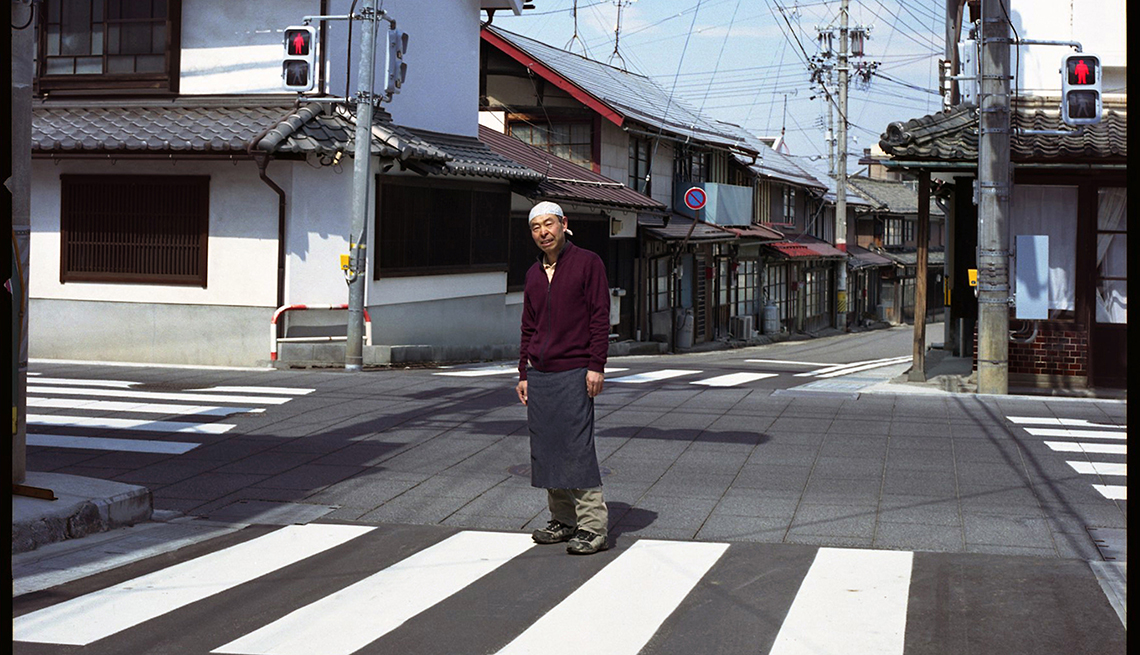 Sake shop owner, man in empty intersection, Nagano, Japan, Longest Living place on Earth