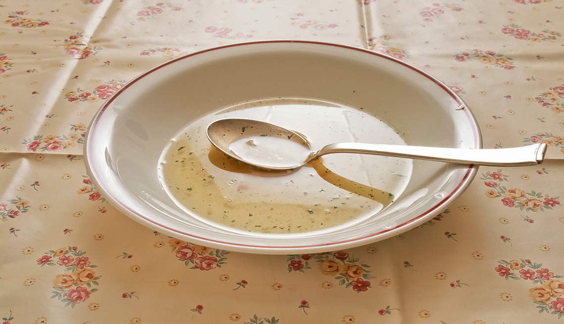 A bowl of clear soup on tablecloth, How Not to Gain Those 10 Holiday Pounds