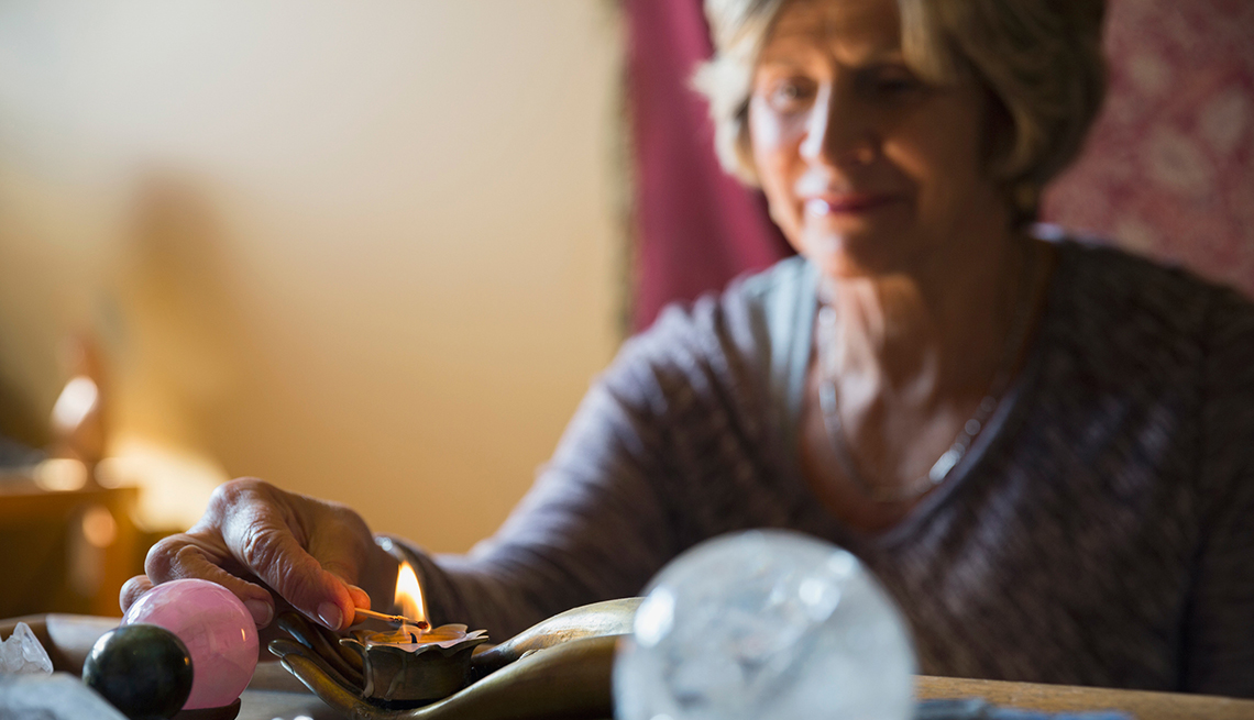 Mature Woman Lighting a Candle, Find Better Balance, Healthy Living