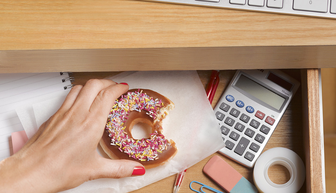 Woman's Hand Reaching For a Donut, Desk Drawer, AARP Health, Healthy Living, Break Out of the See-Food, Eat-Food Rut 