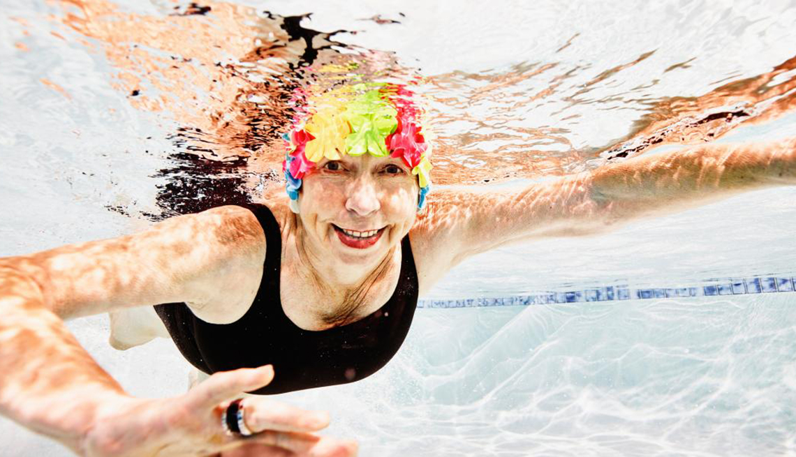 Mature Woman Swimming in a pool, Live Longer, Healthy Living