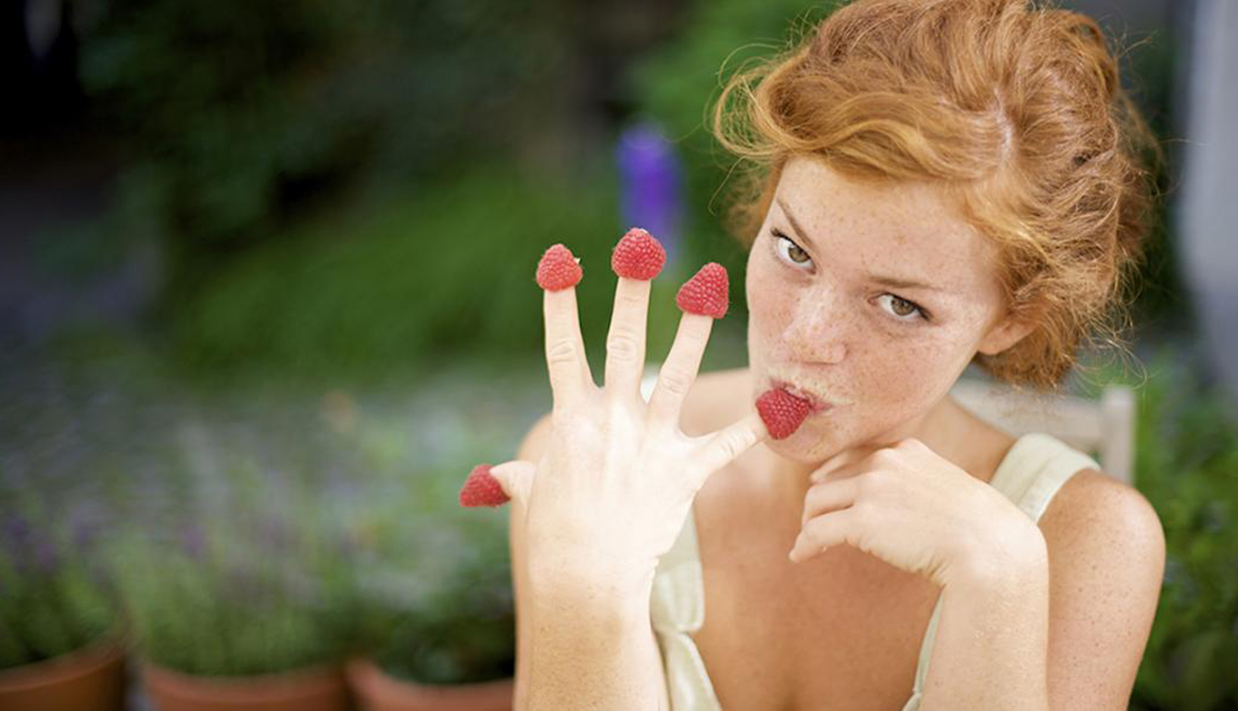 Woman Eating Berries from Fingers, Small Changes, Healthy Living