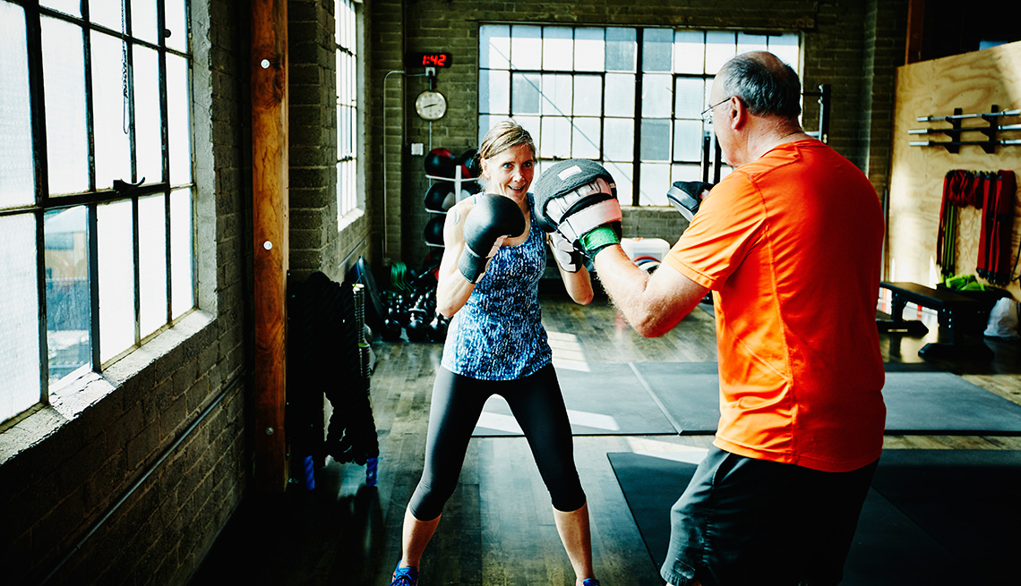 woman and man boxing in a gym