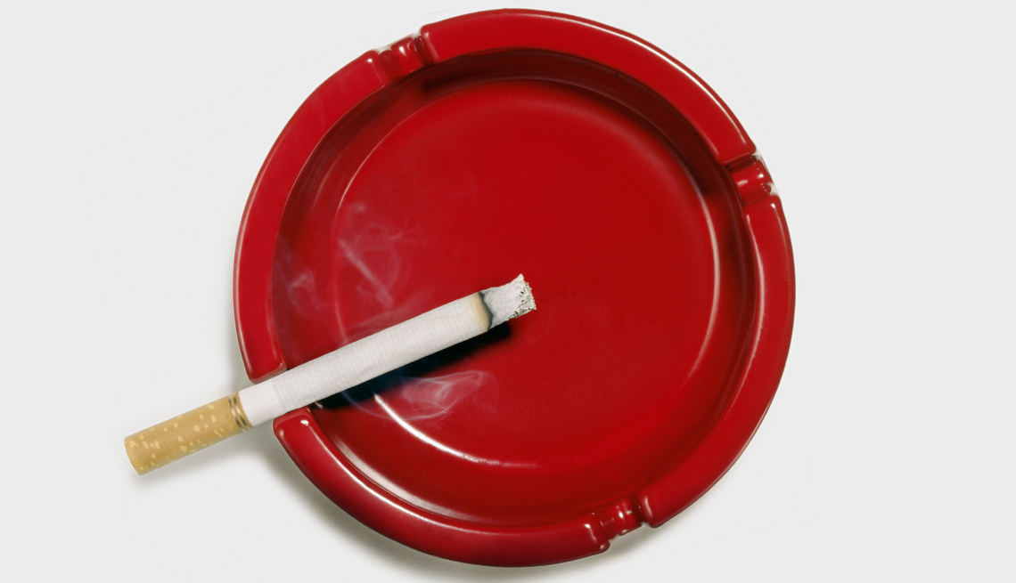 One Cigarette in a red ashtray 