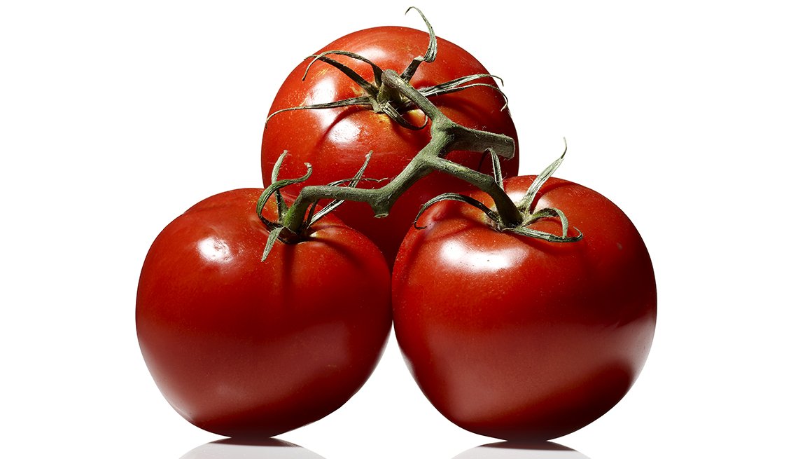 Tres tomates conectados por el tallo.