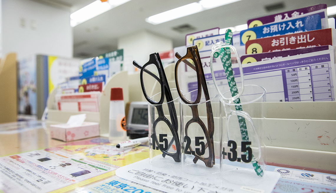 Reading glasses bearing labels  â Please feel free to use this at post office in Tokyo, Japan