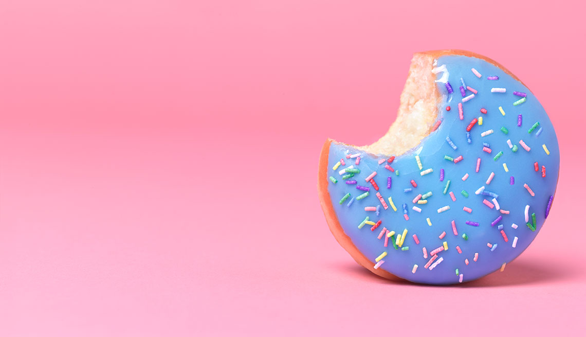Blue doughnut on pink with bite out