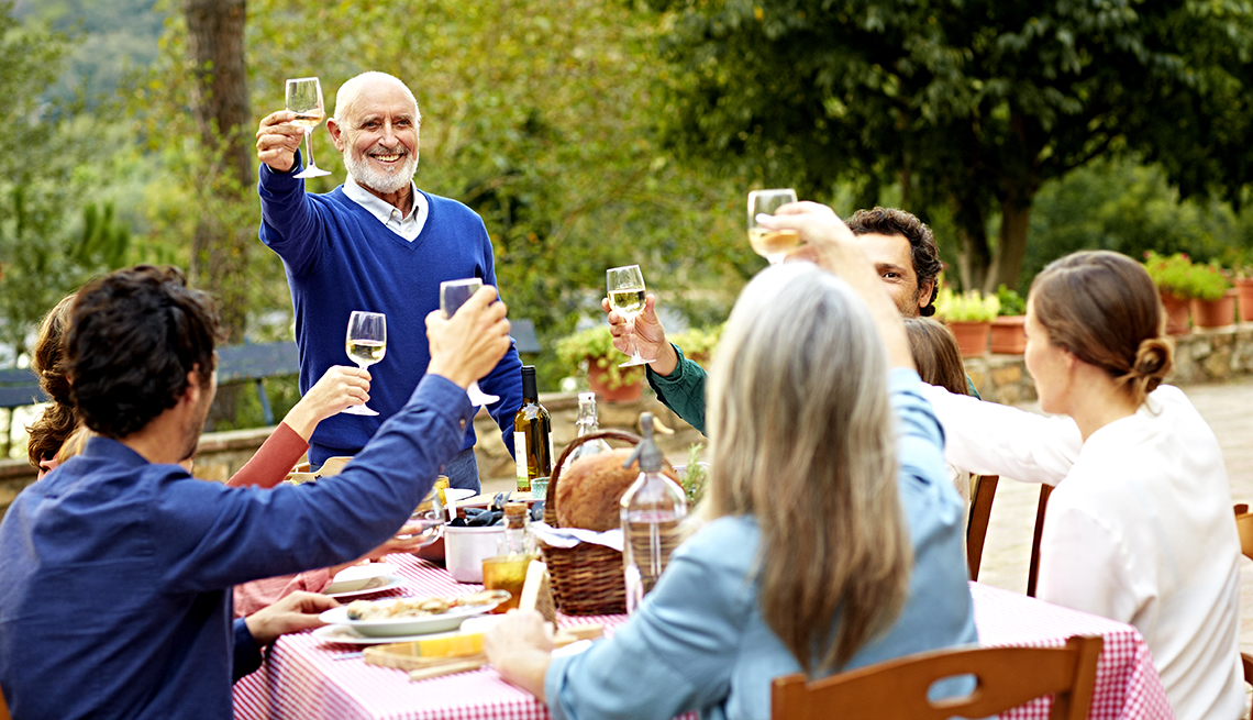 Man in Spain raising a toast with his family