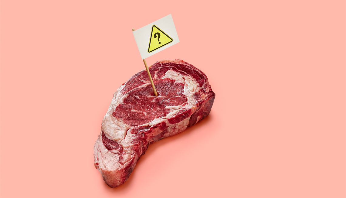 Corte de carne con un palillo y una señal de precaución
